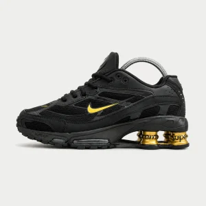 SHOX  SUPREME NEGRA LOGO ORO